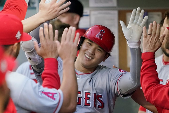 The Los Angeles Angels' Shohei Ohtani is greeted in the dugout after hitting a solo home run on July 9, 2021, in Seattle. 