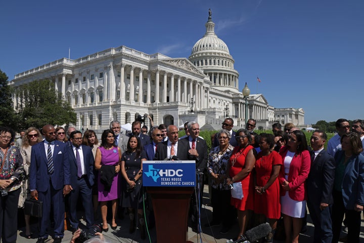 Flanked by other Texas Democrats, state Rep. Chris Turner speaks during a news conference on voting rights.