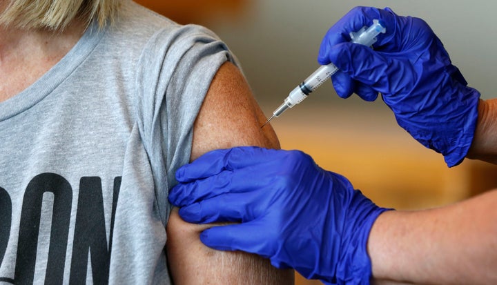 Karen Martin receives a COVID-19 vaccine at a vaccination clinic in Springfield, Mo., in this July 12, 2021, file photo. (Nat