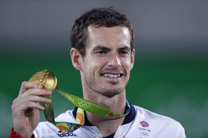 Andy Murray, of England, smiles as he holds up his gold medal at the 2016 Summer Olympics in Rio de Janeiro, Brazil on Aug. 1