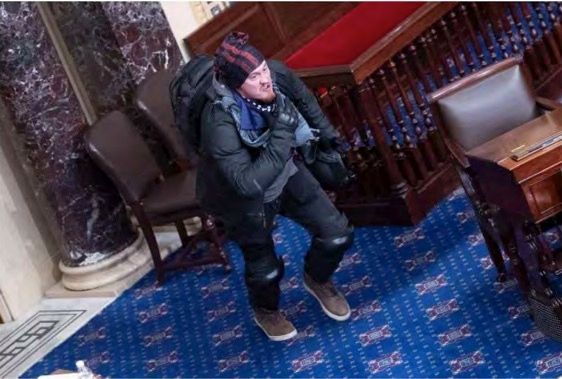 Federal prosecutors used this image as evidence to charge 34-year-old Josiah Colt, who breached the U.S. Capitol and rappelled into the Senate chamber during the Jan. 6 pro-Trump insurrection.