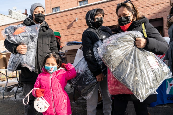 New York Cares volunteers in partnership with a local nonprofit and state Assembly Member Catalina Cruz distribute holidays t