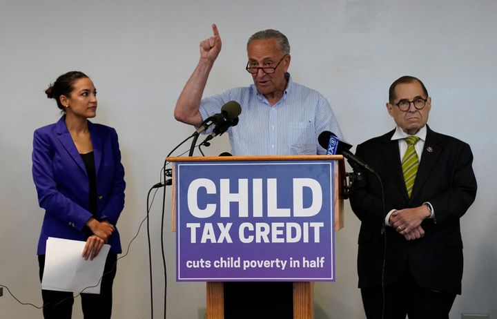 Democratic Reps. Alexandria Ocasio-Cortez and Jerry Nadler of New York listen as Majority Leader Chuck Schumer speaks about the expanded Child Tax Credit during a press conference on July 8.