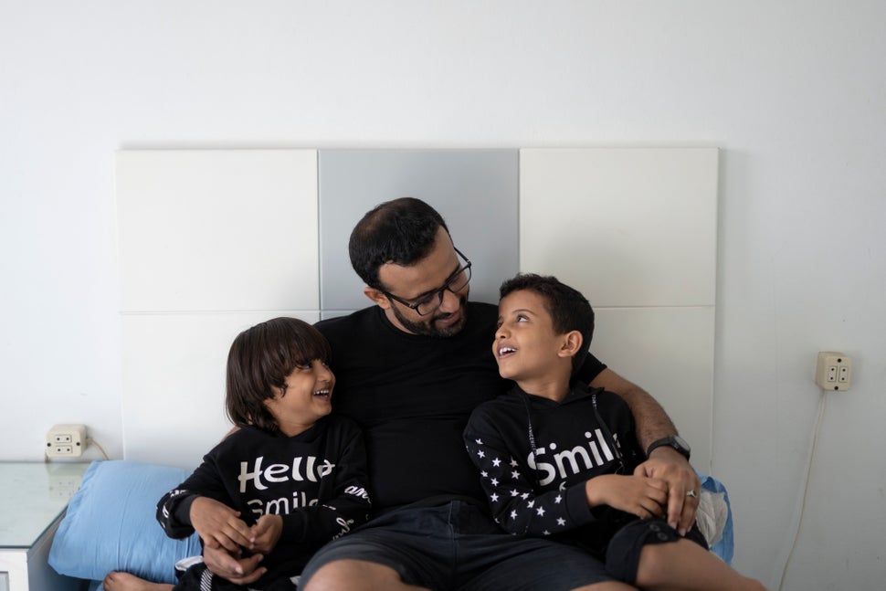 Al-Hasani sits with his sons Mohamed and