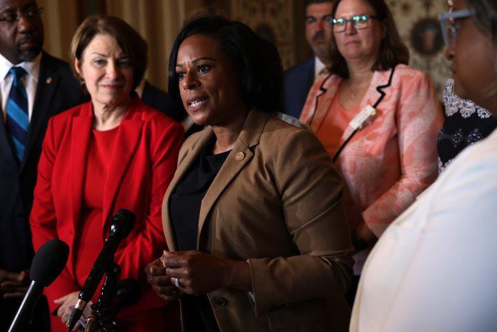 Texas state Rep. Nicole Collier (center) speaks to reporters as U.S. Sens. Amy Klobuchar (D-Minn.) and U.S. Sen. Raphael Warnock (D-Ga.) stand to her right after a meeting between the senators and members of the Texas House Democratic Caucus at the U.S. Capitol on Tuesday.