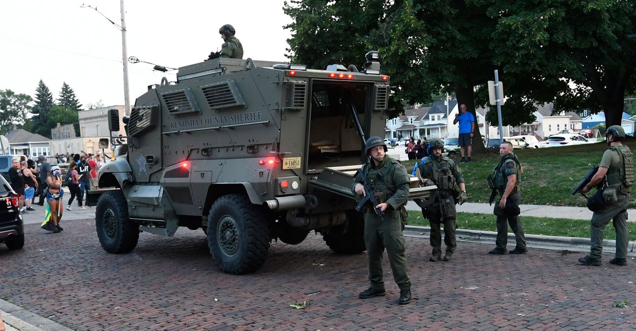 Officers arrive at the scene of a protest in a Kenosha County Sheriff’s Department armored vehicle on Aug. 26, 2020.