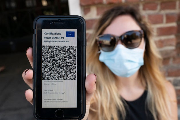 TURIN, ITALY - JUNE 30: A woman shows Italy's Covid-19 Green Pass for post-vaccine travel on a smartphone...