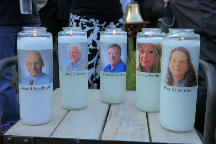 Candles honoring Gerald Fischman, Rob Hiassen, John McNamara, Rebecca Smith, and Wendi Winters flicker as the sun sets during a candlelight vigil on June 29, 2018, at Annapolis Mall for the five Capital Gazette employees slain during a shooting spree in their newsroom. (Karl Merton Ferron/Baltimore Sun/Tribune News Service via Getty Images)