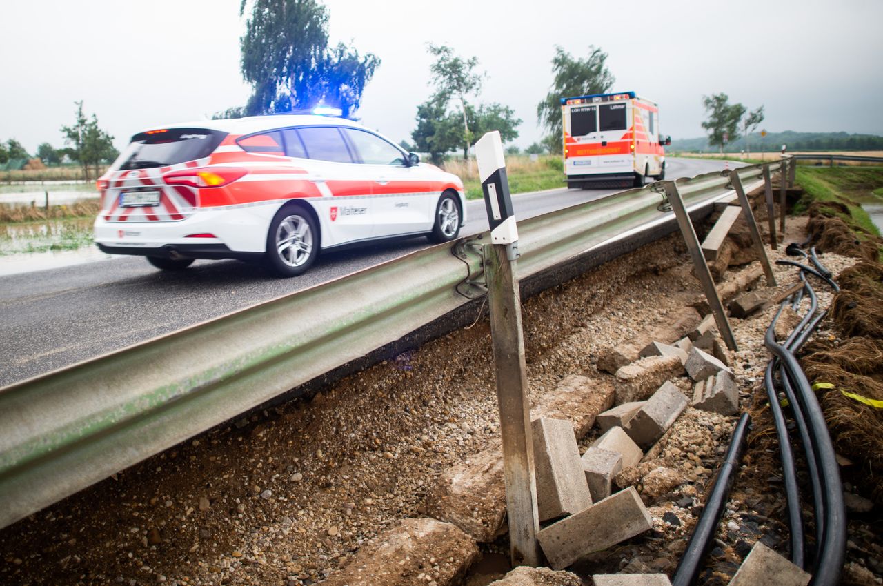 15 July 2021, North Rhine-Westphalia, Kirchheim: Emergency vehicles drive over a washed out road. The heavy rainfall during the night caused mudslides and flooding. Photo: Jonas Güttler/dpa (Photo by Jonas Güttler/picture alliance via Getty Images)