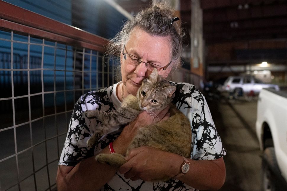 Dee McCarley hugs her cat Bunny, whom she took with her while evacuating from the Bootleg Fire on Wednesday.