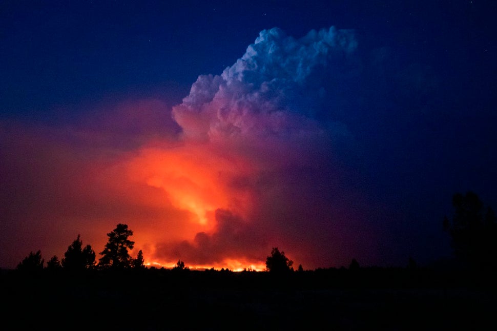 In this photo provided by the Oregon Office of State Fire Marshall, flames and smoke rise from the Bootleg fire in southern O