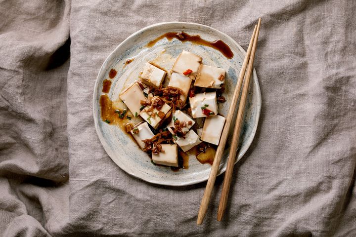 Silk tofu japanese soy cheese sliced cubes with chili ginger, chive and soy sauce.