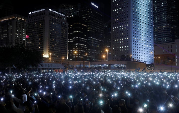 A photo taken by journalist Danish Siddiqui captures anti-government protesters as they hold up their mobile phones during a