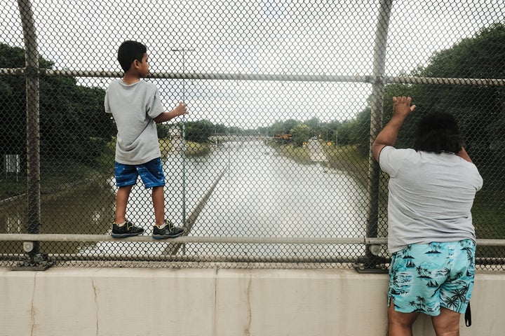 Detroit residents observe a stretch of I-94 under several feet of water after rains flooded parts of Metro Detroit last month.