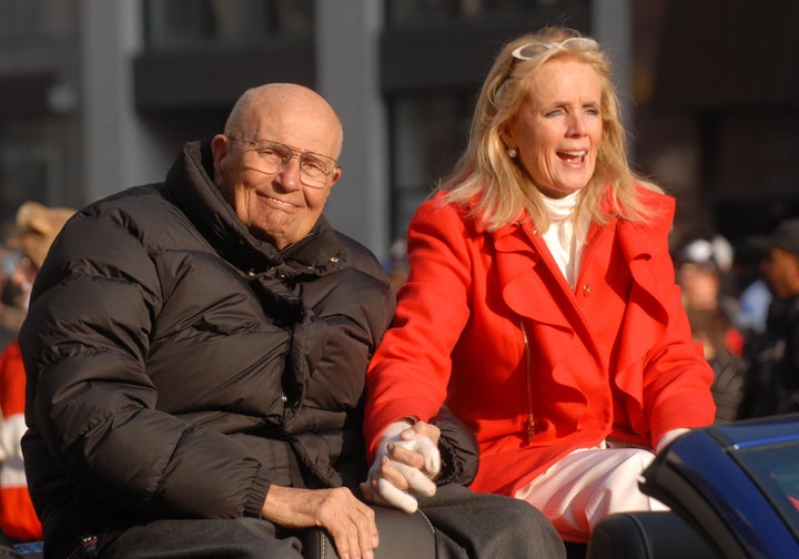 John and Debbie Dingell in 2012, at the Detroit Thanksgiving Day parade, while he was still serving in Congress. She ran for and won the election for his seat when he retired. Her experience during his final years, when he needed various forms of home care, is one reason she is pushing for a dramatic increase in government funding for such services.