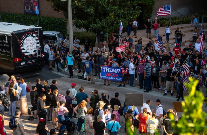 Shouting protesters face off against supporters of Matt Gaetz outside City hall in Riverside, California, Saturday after Gaetz's "America First" rally was cancelled by a third venue in the state just hours before the event.