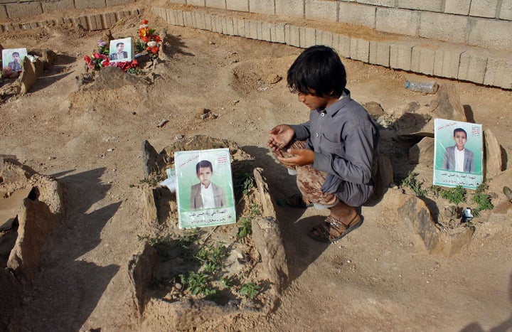 A Yemeni child at the graves of schoolboys who were killed in an August 2018 airstrike by a military coalition that included the UAE.