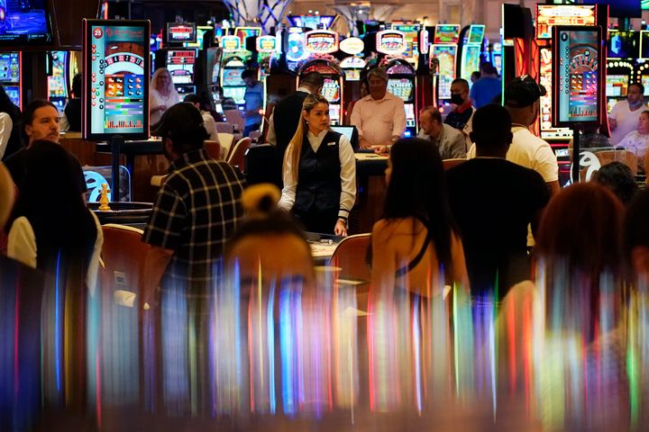 Crowds walk through the Resorts World Las Vegas casino during its opening night last month. Elected officials in tourism-dependent Las Vegas are worried about public health and the economic effects of a spike in COVID-19 cases, particularly involving the highly contagious delta variant.
