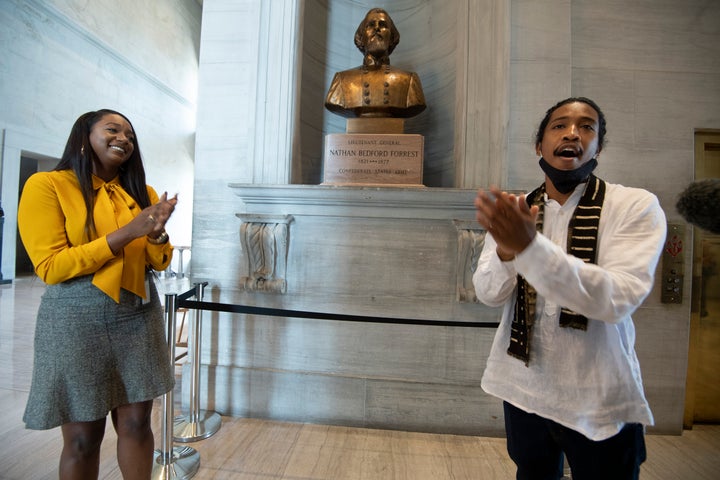 State Rep. London Lamar, left, sings with activist Justin Jones in front of the Nathan Bedford Forrest bust in the State Capitol Thursday, July 22, 2021, in Nashville, Tenn. (George Walker IV/The Tennessean via AP)