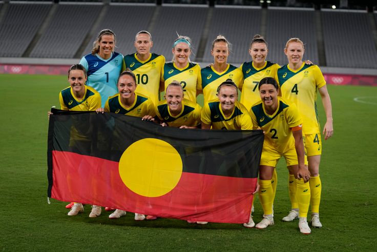 Australia players pose for a group photo with an Indigenous flag prior to the women's soccer match against New Zealand at the 2020 Summer Olympics on Wednesday.