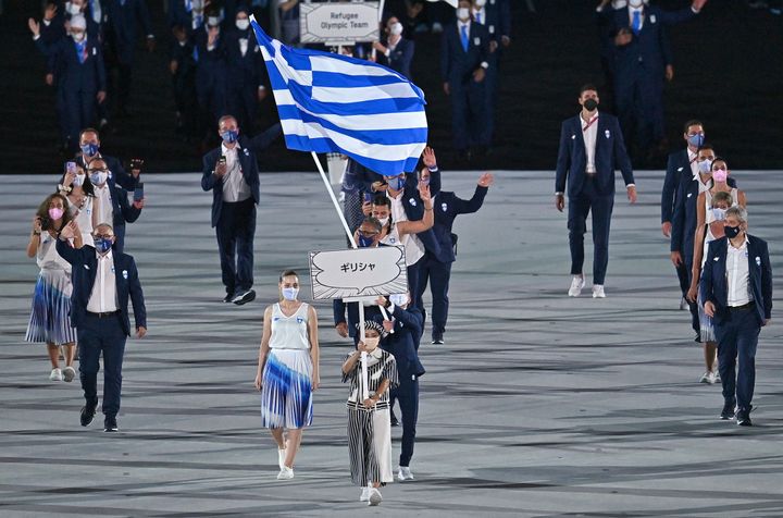 Greece's flag bearer Anna Korakaki and Greece's flag bearer Eleftherios Petrounias and their delegation enter the Olympic Stadium during the opening ceremony of the Tokyo 2020 Olympic Games, in Tokyo, on July 23, 2021. (Photo by Ben STANSALL / AFP) (Photo by BEN STANSALL/AFP via Getty Images)