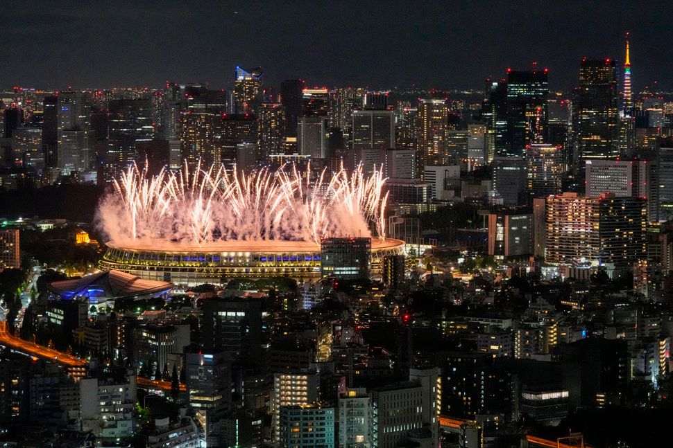 Fireworks illuminate over the National Stadium during the Tokyo Olympics opening ceremony.