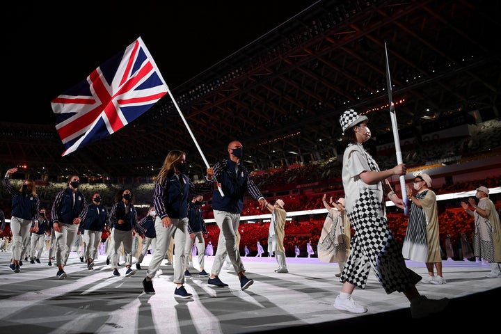 TOKYO, JAPAN - JULY 23: Flag bearers Hannah Mills and Mohamed Sbihi of Team Great Britain leads their team out during the Opening Ceremony of the Tokyo 2020 Olympic Games at Olympic Stadium on July 23, 2021 in Tokyo, Japan. (Photo by Matthias Hangst/Getty Images)