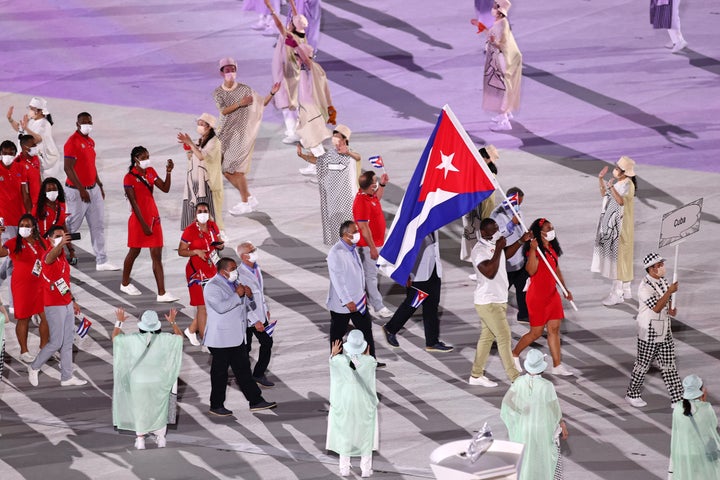 TOKYO, JAPAN - JULY 23: Flag bearers Yaime Perez and Mijain Lopez Nunez of Team Cuba during the Opening Ceremony of the Tokyo 2020 Olympic Games at Olympic Stadium on July 23, 2021 in Tokyo, Japan. (Photo by Maja Hitij/Getty Images)