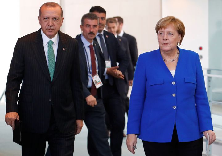 German Chancellor Angela Merkel and Turkish President Tayyip Erdogan arrive for a news conference at the chancellery in Berlin, Germany, September 28, 2018. REUTERS/Fabrizio Bensch