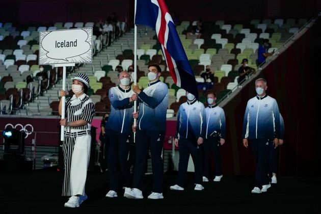 Snaefridur Sol Jorunnardottir and Anton Mckee, of Iceland, carry their country's flag during the opening