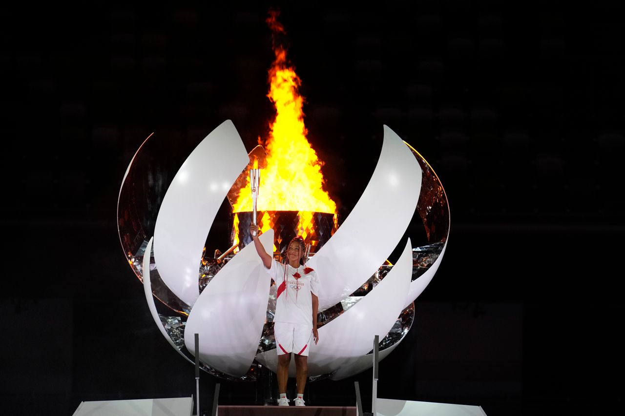 Japan's Naomi Osaka lights the cauldron during the opening ceremony in the Olympic Stadium at the 2020 Summer Olympics, Friday, July 23, 2021, in Tokyo, Japan. (AP Photo/Natacha Pisarenko)
