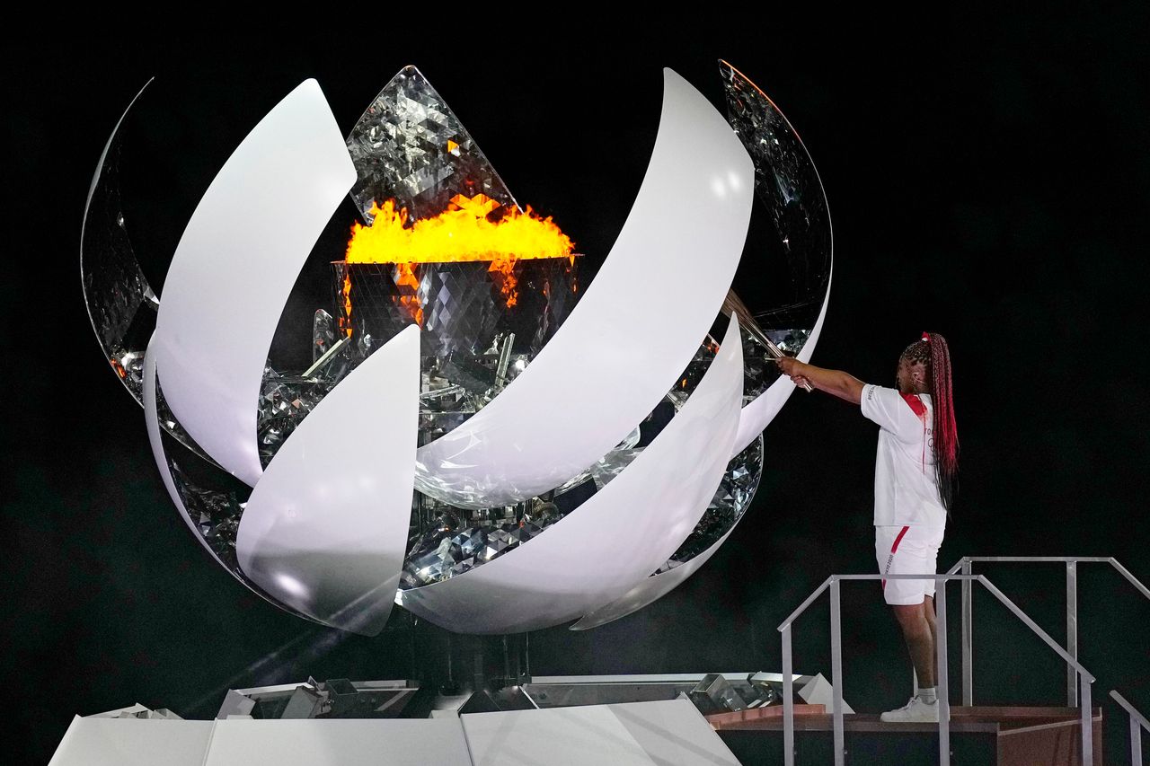 Naomi Osaka lights the Olympic flame during the opening ceremony in the Olympic Stadium at the 2020 Summer Olympics, Friday, July 23, 2021, in Tokyo, Japan. (AP Photo/David J. Phillip)