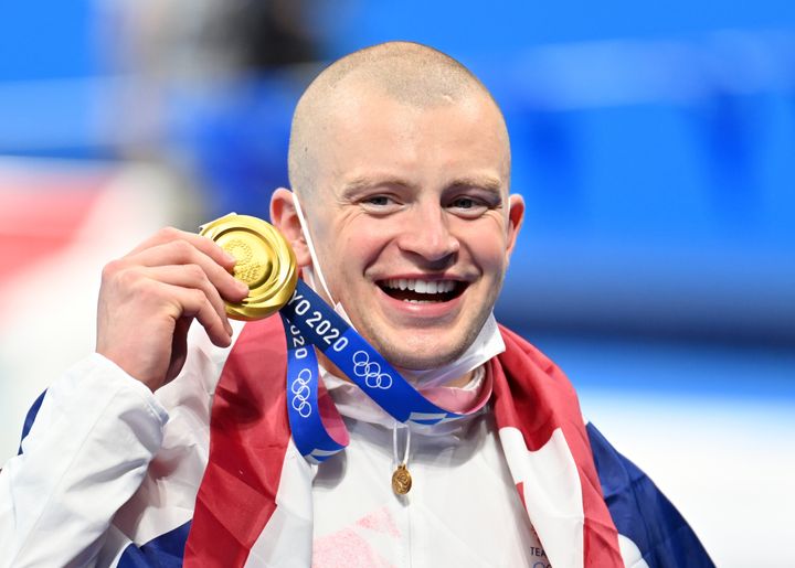 Adam Peaty of Team Great Britain poses with his medal after winning the Men's 100m Breaststroke Final of the Tokyo 2020 Olympic Games at Tokyo Aquatics Centre in Tokyo, Japan on July 26, 2021. (Photo by Mustafa Yalcin/Anadolu Agency via Getty Images)