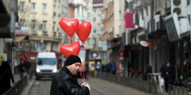People with balloons in the shape of hearts on Valentine's Day in the center of Sofia, on February 14, 2017. (Photo by Hristo Vladev/NurPhoto via Getty Images)