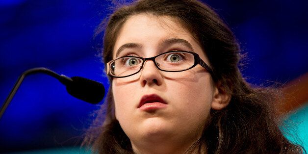 Mary Jo Johnson, 12, of Dayton, Ohio, reacts as she correctly spells her word "indigenous" during the 2015 Scripps National Spelling Bee, Wednesday, May 27, 2015, in Oxon Hill, Md. (AP Photo/Andrew Harnik)