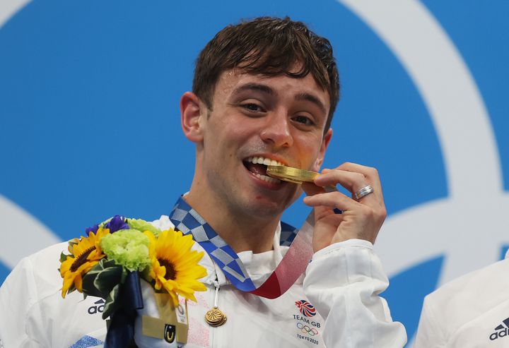 Tom Daley poses with his gold medal after the Men's Synchronised 10m Platform Final 