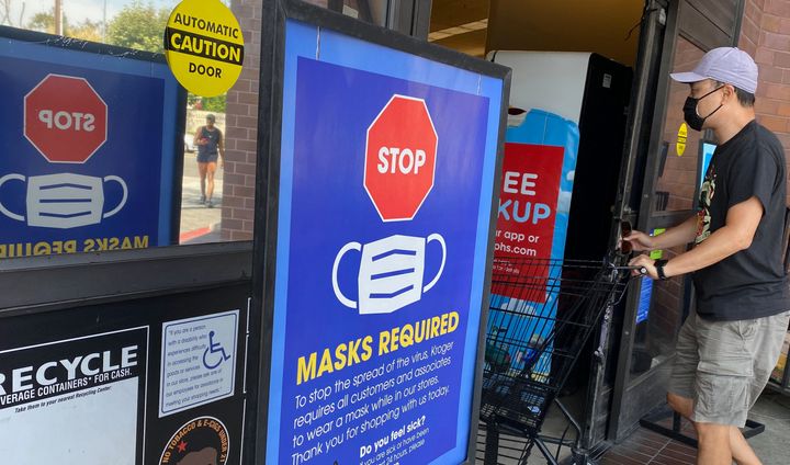 People shop at a grocery store enforcing the wearing of masks in Los Angeles on July 23.