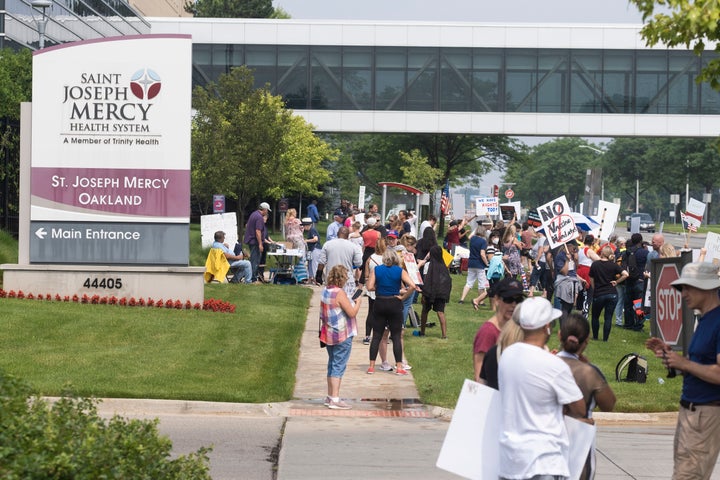 Health care workers and others gathered at several hospitals throughout Michigan on Saturday to protest the recent announcement by Trinity Health and Henry Ford Health systems that nurses and other health workers under their employment will be required to receive a COVID-19 vaccine.