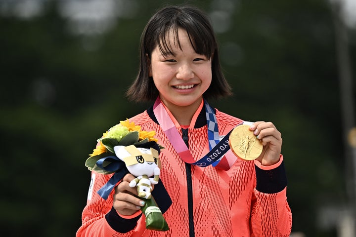 Japan's Momiji Nishiya poses with her gold medal for the skateboarding women's street final of the Tokyo 2020 Olympic Games.