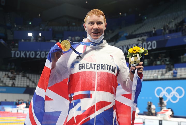 Tom Dean of Great Britain poses with his medal after winning the Men's 200m Freestyle final on day four of the Tokyo 2020 Olympic Games 