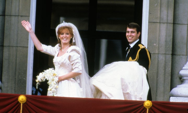 Sarah Ferguson and Prince Andrew stand on the balcony of Buckingham Palace and wave at their wedding on July 23, 1986, in London.