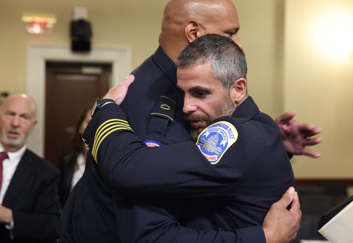 Officer Harry Dunn and Officer Michael Fanone embrace.