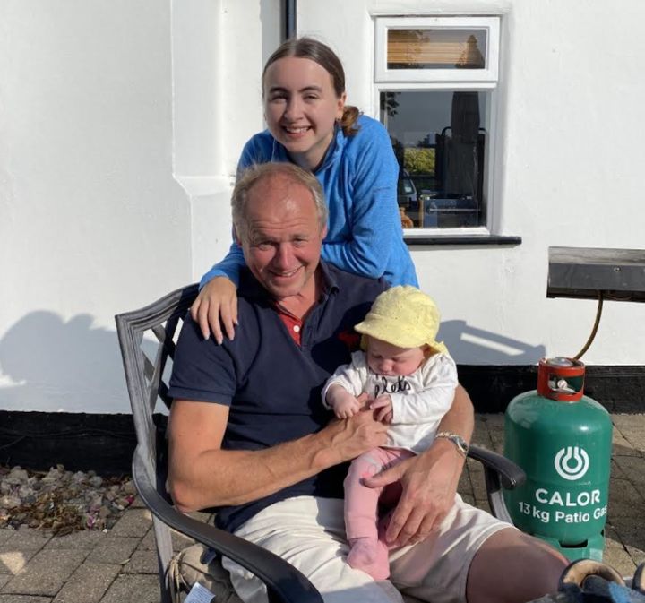 The author with her dad and her baby sister in her dad's garden in September 2020.