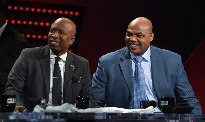 NBA analysts Kenny Smith and Charles Barkley laugh during a live telecast of "NBA on TNT" in 2017.