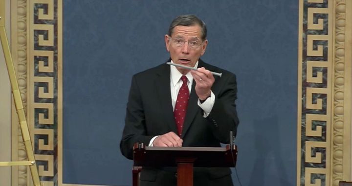 Sen. John Barrasso holds up a tree spike during a July 28 speech on the Senate floor in which he condemned Stone-Manning's nomination to lead the Bureau of Land Management.