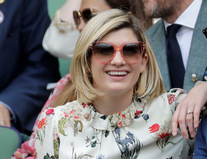 FILE - In this file photo dated Saturday, July 13, 2019, actress Jodie Whittaker sits in the Royal Box on Centre Court to watch the women's singles final match between Serena Williams of the United States and Romania's Simona Halep on day twelve of the Wimbledon Tennis Championships in London. The BBC said Thursday July 29, 2021, that star Jodie Whittaker will leave the Doctor Who science fiction series next year, but before leaving Whittaker will appear in a new six-episode series in 2021 and three special episodes in 2022.(AP Photo/Ben Curtis, FILE)