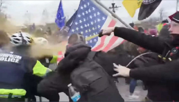 The FBI says this image shows Andrew Taake pepper spraying a D.C. Metropolitan Police officer at the Capitol on Jan. 6.