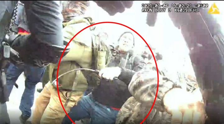 The FBI says this image shows Taake holding a metal whip as he battled officers at the Capitol on Jan. 6.