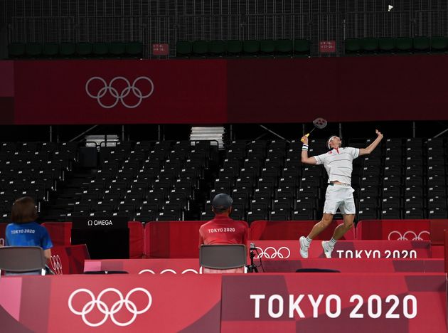 Viktor Axelsen of Denmark competes in a near-empty stadium during a men's singles badminton match during the Tokyo Games.
