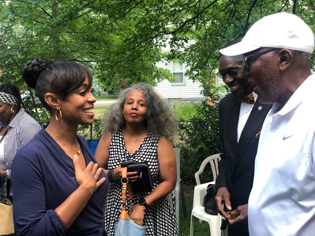 Shontel Brown, left, talks with voters. She and Turner have accused one another of corruption and insufficient loyalty to the